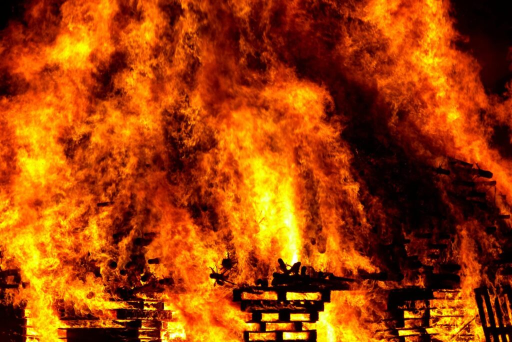 Intense flames engulf wooden pallets in a breathtaking display of fire and heat.