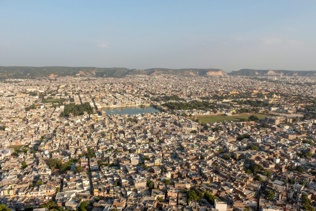 Panoramic aerial view of Jaipur, showcasing urban landscape and architectural heritage.